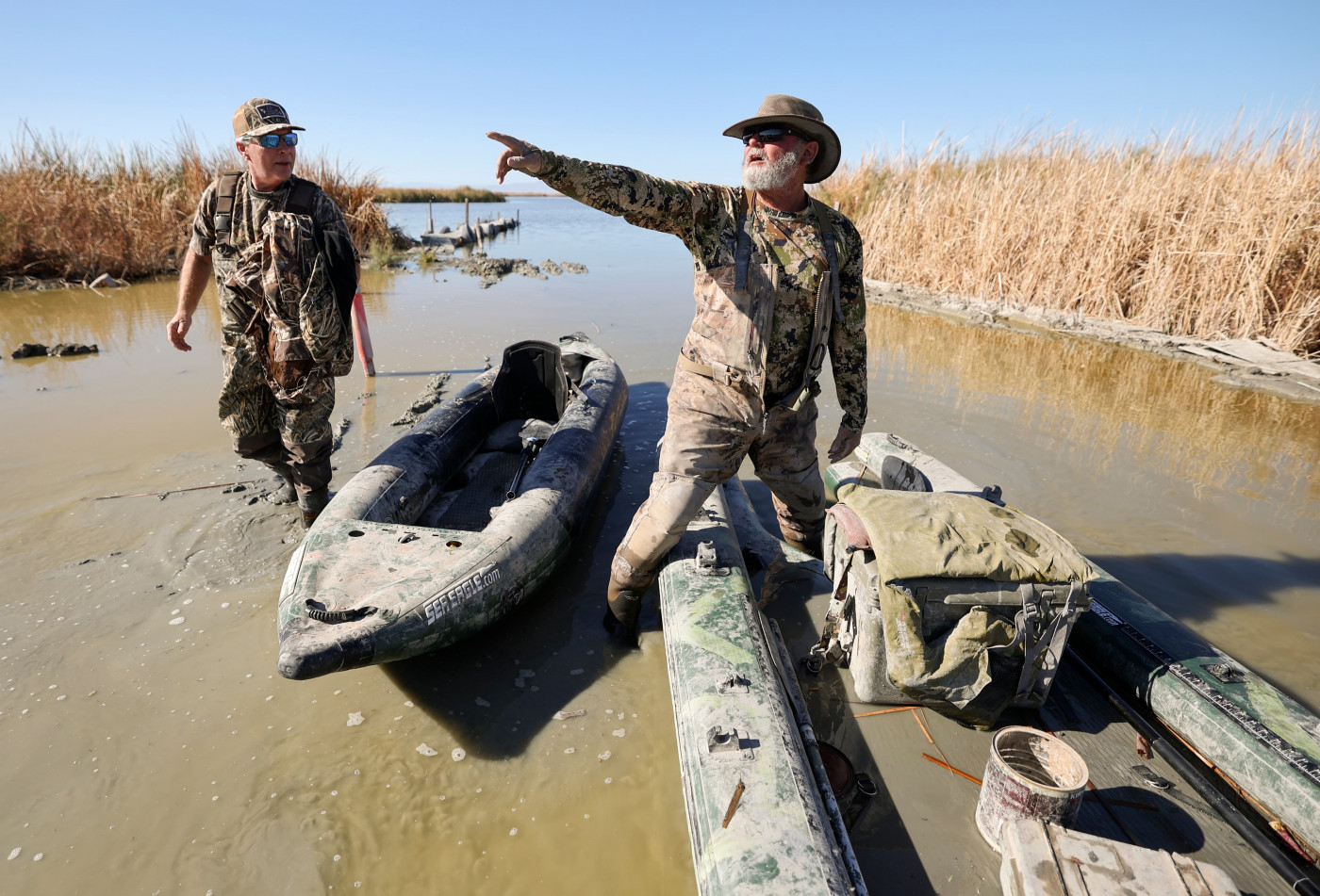 David Williams listens to his duck hunting guide Breck Dickinson as they get ready to load their boats into a truck near Red Hill Park, in Imperial County, Calif., on Tuesday, Dec. 12, 2023. Dickinson has been hunting in the area for around 30 years and has watched the bird populations change along with changing water levels of the Salton Sea. He also said brown pelicans disappeared as fish in the lake died off, eliminating their food source.Kristin Murphy, Deseret News